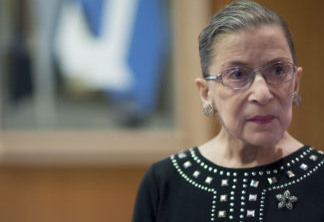 Ruth Bader Ginsburg, associate justice of the U.S. Supreme Court, stands in her chambers following an interview in Washington, D.C., U.S., on Friday, Aug. 23, 2013. Ginsburg, 80, the oldest member of the Supreme Court and appointed to the court in 1993 by Democratic President Bill Clinton, has said on several occasions that she wants to match the longevity of Justice Louis Brandeis, who was 82 when he stepped down in 1939. Photographer: Andrew Harrer/Bloomberg via Getty Images