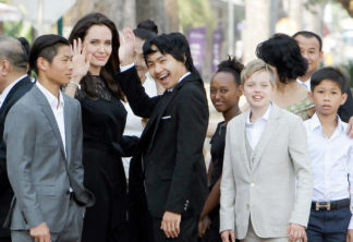 Hollywood actress Angelina Jolie, second from left, waves with her adopted children Pax, left, Maddox, center, Zahara, third from right, and Shiloh, second from right, while they wait to meet Cambodia's King Norodom Sihamoni in Siem Reap province, Cambodia, Saturday, Feb. 18, 2017. Jolie on Saturday launches her two-day film screening of "First They Killed My Father" in the Angkor complex in Siem Reap province. (AP Photo/Heng Sinith)