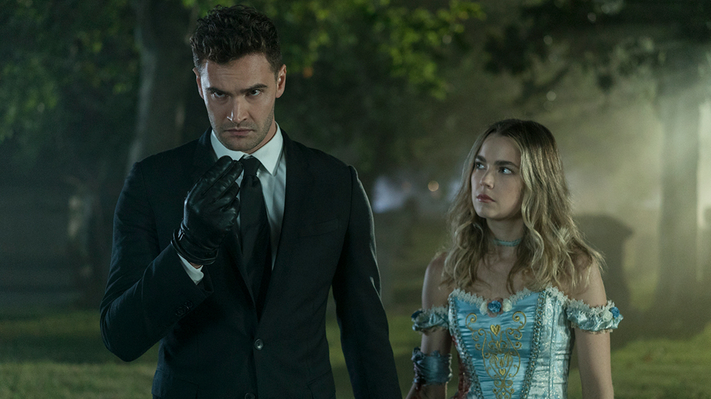 Into The Dark -- "The Body" - A sophisticated hitman with a cynical view on modern society finds his work made more difficult when he has to transport a body on Halloween night, but everyone is enamored by what they think is his killer costume. Wilkes (Tom Bateman) and Maggie (Rebecca Rittenhouse), shown. (Photo by: Richard Foreman, Jr.  SMPSP/Hulu)