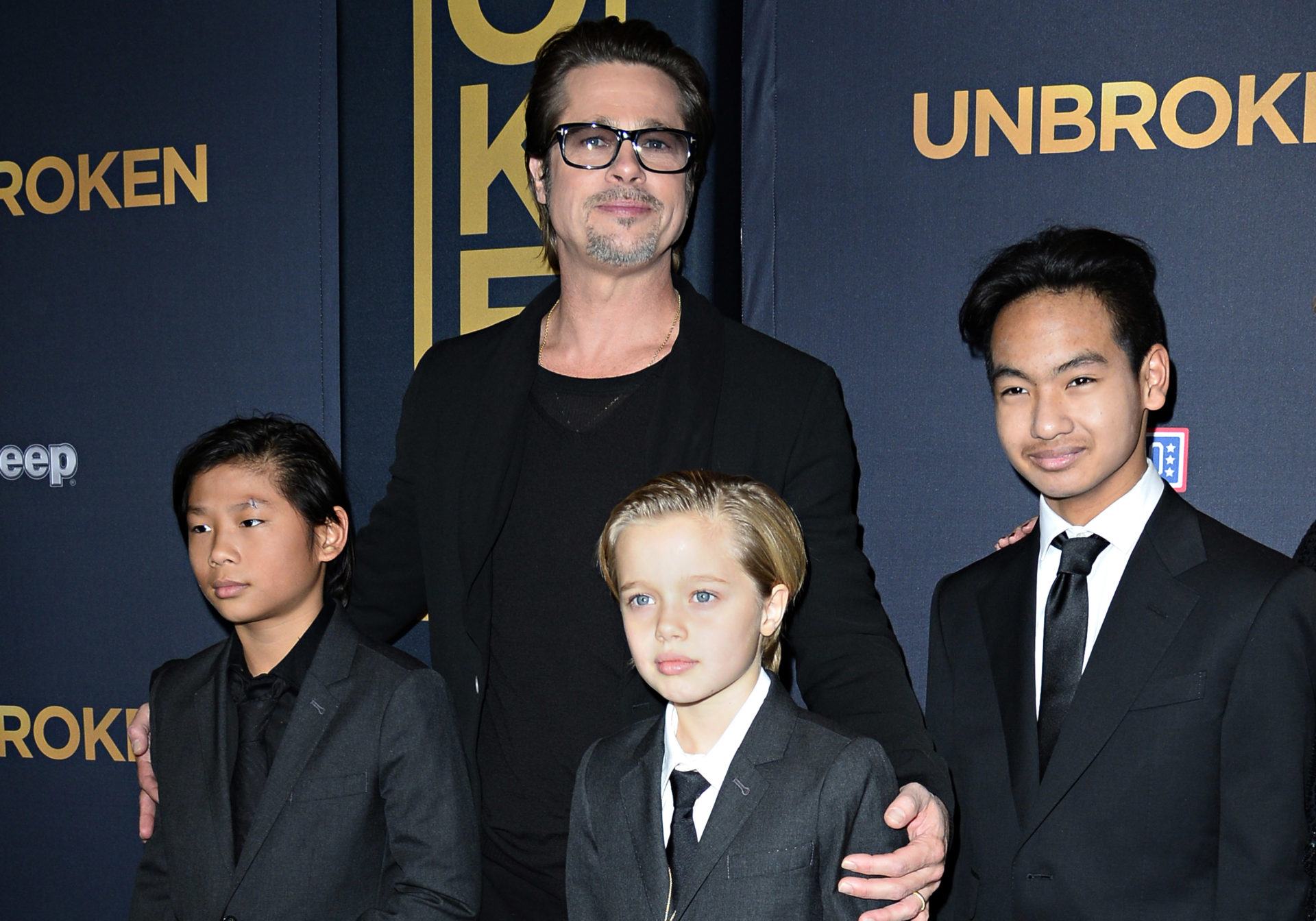 (FILES) This file photo taken on December 15, 2014 shows actor Brad Pitt and children Pax Jolie-Pitt (L), Shiloh Jolie-Pitt (C) and Maddox Jolie-Pitt as they arrive for the US premiere of Universal Pictures "Unbroken,"  at the Dolby Theatre in Hollywood, California.  
Brad Pitt is under investigation by US authorities after being accused of physically and verbally abusing his children during an angry outburst, TMZ reported September 22, 2016. According to the entertainment news site the Los Angeles Police Department began probing Pitt based on an anonymous tip received by the LA County Department of Children and Family Services, as is systematic following any report of child abuse.
 / AFP PHOTO / ROBYN BECKROBYN BECK/AFP/Getty Images